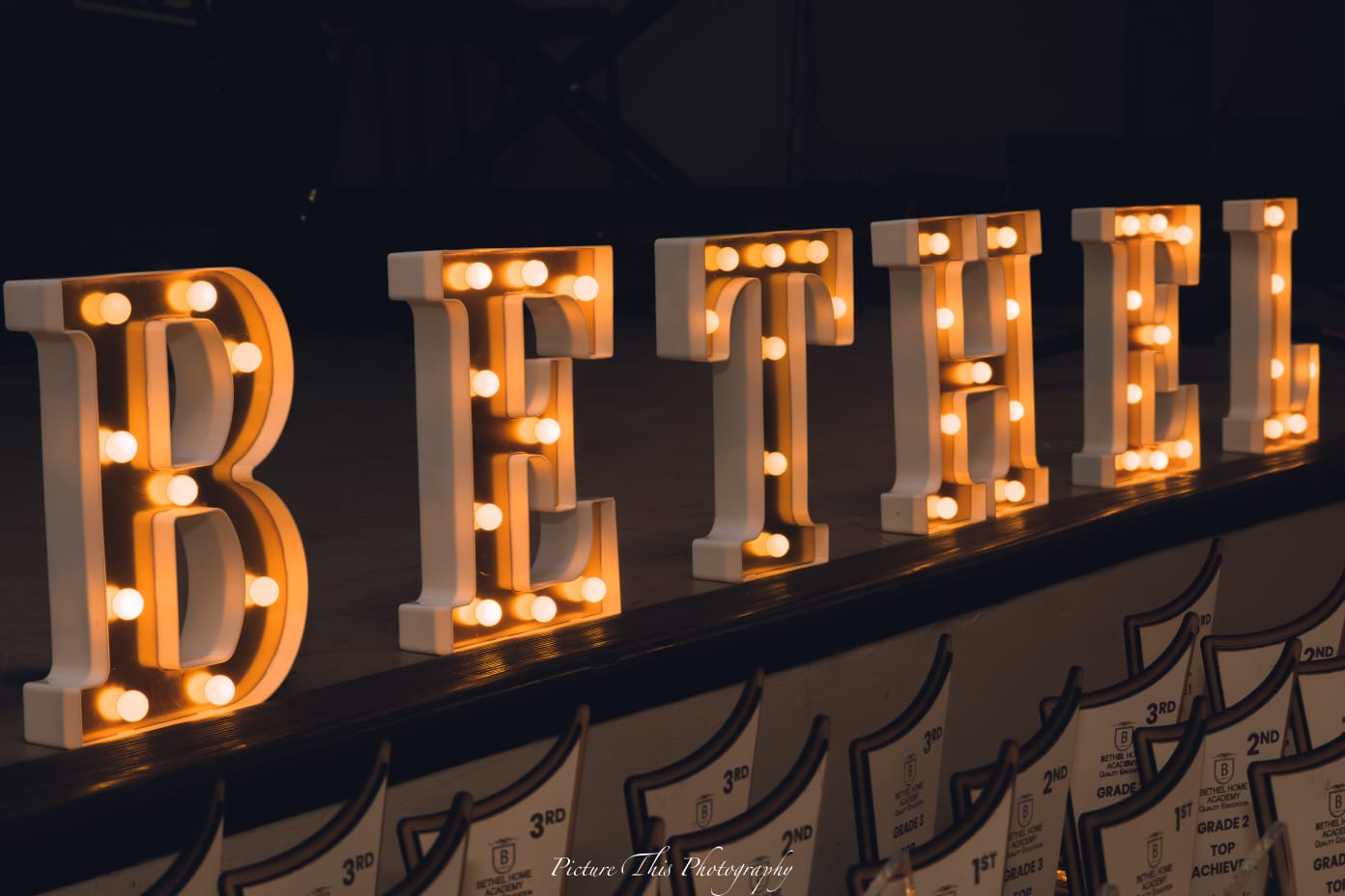 Bethel Academy sign with achievement trophies