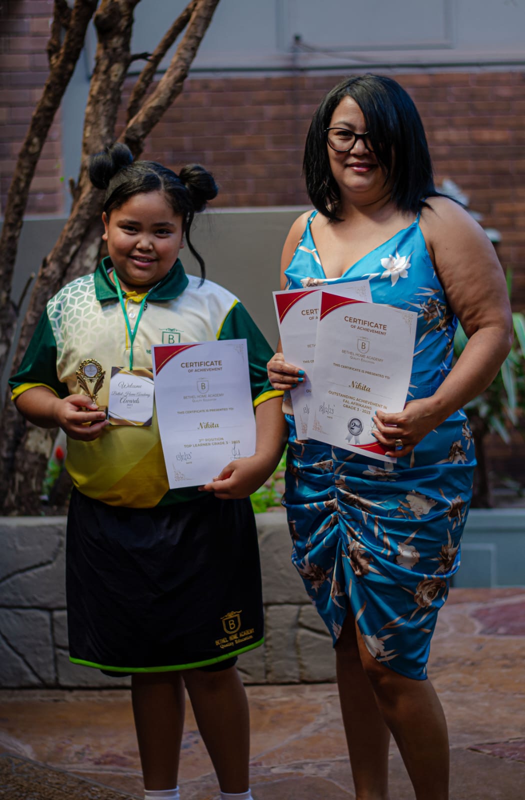 Student receiving an award with a parent